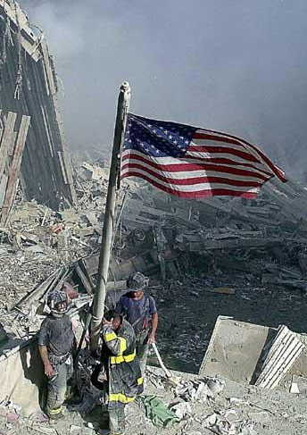 NYFD fighters raising the U.S. flag at the World Trade Center site.